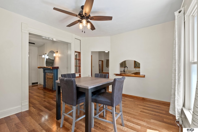 1346 G St, Pawnee City, NE 68420 - dining area featuring a ceiling fan, wood finished floors, and baseboards