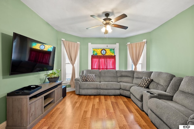 1346 G St, Pawnee City, NE 68420 - living room with light wood-style floors, ceiling fan, and baseboards