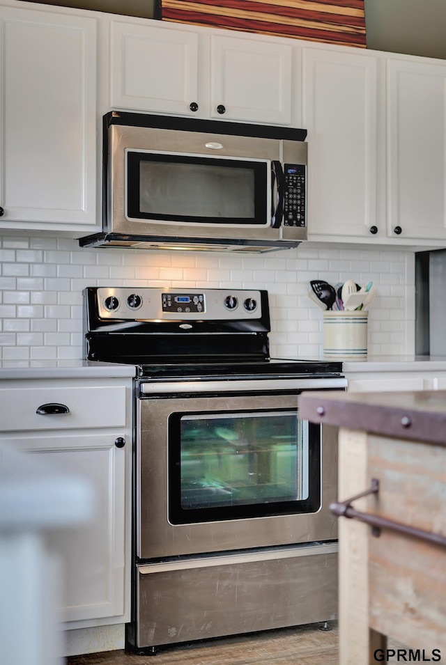 4441 W Hub Hall Dr, Lincoln, NE 68528 - kitchen with appliances with stainless steel finishes, white cabinetry, and tasteful backsplash