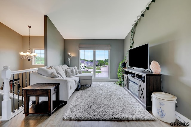 4441 W Hub Hall Dr, Lincoln, NE 68528 - living area with a chandelier, healthy amount of natural light, baseboards, lofted ceiling, and wood finished floors