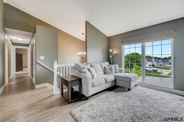 4441 W Hub Hall Dr, Lincoln, NE 68528 - living area featuring lofted ceiling, light wood-style flooring, a chandelier, and baseboards