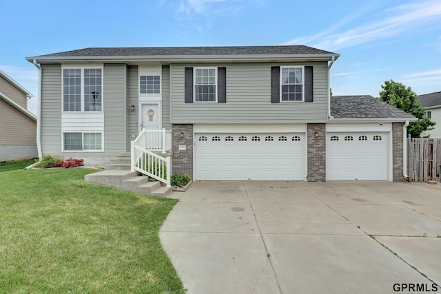 4441 W Hub Hall Dr, Lincoln, NE 68528 - split foyer home featuring driveway, brick siding, a garage, and an attached garage