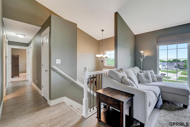4441 W Hub Hall Dr, Lincoln, NE 68528 - living area with a chandelier, wood finished floors, baseboards, and high vaulted ceiling