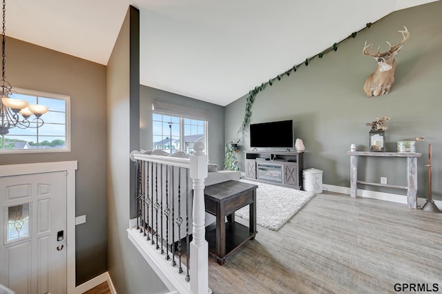 4441 W Hub Hall Dr, Lincoln, NE 68528 - foyer featuring lofted ceiling, a chandelier, wood finished floors, and baseboards