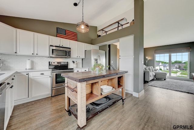 4441 W Hub Hall Dr, Lincoln, NE 68528 - kitchen with appliances with stainless steel finishes, high vaulted ceiling, tasteful backsplash, white cabinetry, and light wood-style floors