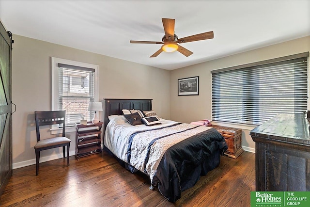 2028 N 55th St, Omaha, NE 68104 - bedroom with dark wood-style flooring, a barn door, baseboards, and a ceiling fan