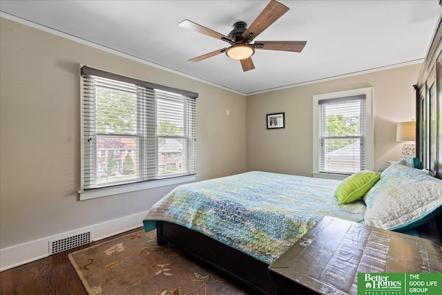 2028 N 55th St, Omaha, NE 68104 - bedroom featuring baseboards, wood finished floors, crown molding, and a ceiling fan