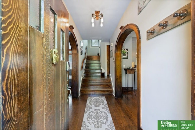 2028 N 55th St, Omaha, NE 68104 - hallway featuring wood finished floors, arched walkways, and stairs