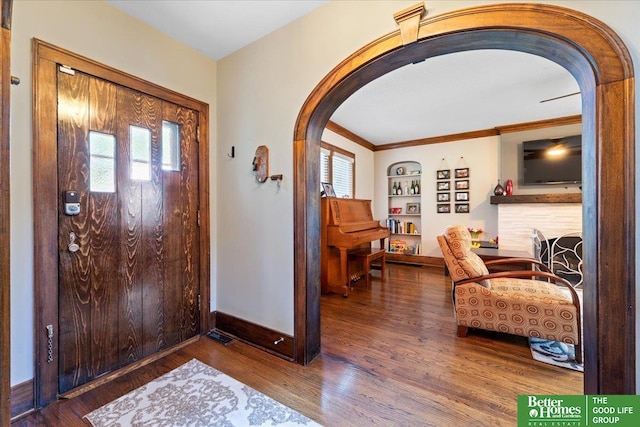2028 N 55th St, Omaha, NE 68104 - foyer featuring arched walkways, baseboards, plenty of natural light, and crown molding