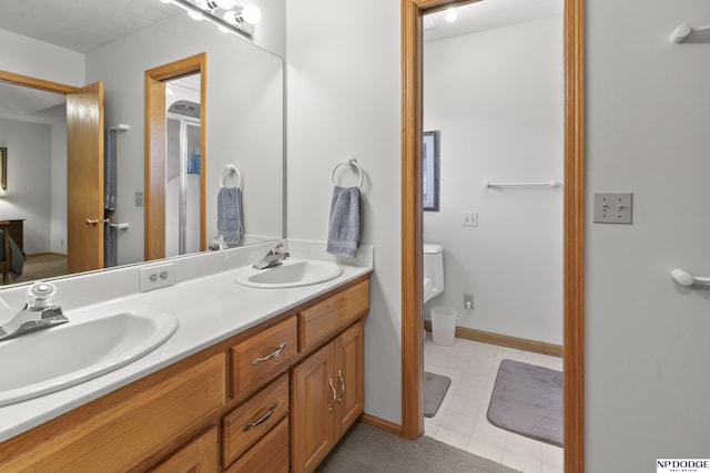 S-1196 N Lake Shore Dr, Fremont, NE 68025 - full bath featuring toilet, double vanity, and baseboards
