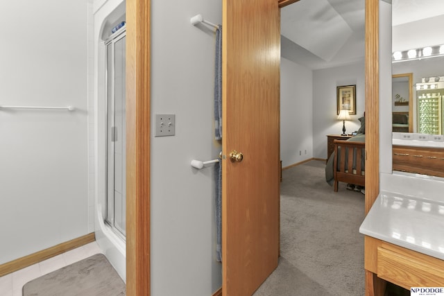 S-1196 N Lake Shore Dr, Fremont, NE 68025 - bathroom with vanity, a shower with door, and baseboards