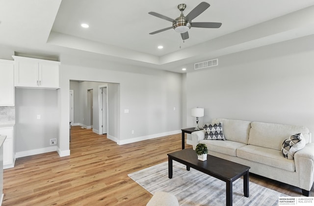 6320 Harvest Dr, Papillion, NE 68133 - living room with a ceiling fan, baseboards, light wood finished floors, a raised ceiling, and recessed lighting