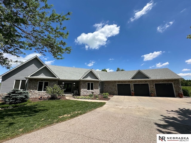 10955 N 58th Plz, Omaha, NE 68152 - view of front of property with stone siding, an attached garage, driveway, and a front yard