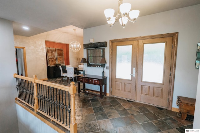 10955 N 58th Plz, Omaha, NE 68152 - foyer entrance featuring a chandelier, stone finish flooring, and baseboards