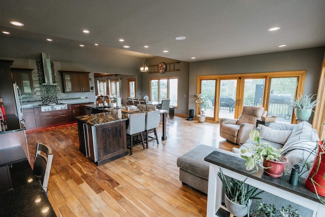 10955 N 58th Plz, Omaha, NE 68152 - living area featuring light wood-style floors, recessed lighting, and vaulted ceiling