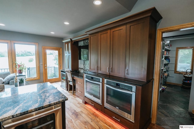 10955 N 58th Plz, Omaha, NE 68152 - kitchen with stainless steel oven, beverage cooler, recessed lighting, and dark stone counters