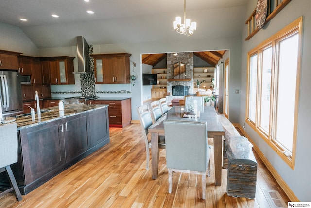 10955 N 58th Plz, Omaha, NE 68152 - kitchen featuring lofted ceiling, light wood-style floors, appliances with stainless steel finishes, a chandelier, and a sink