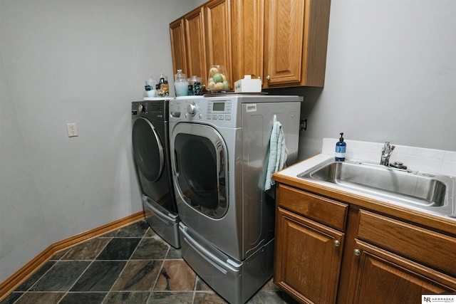 10955 N 58th Plz, Omaha, NE 68152 - laundry room with washing machine and dryer, cabinet space, dark stone finish flooring, and baseboards