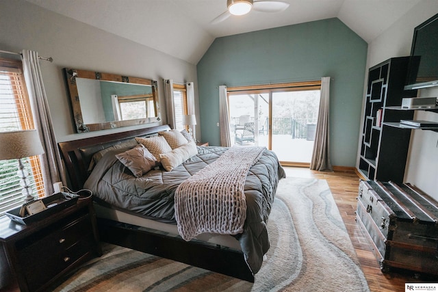 10955 N 58th Plz, Omaha, NE 68152 - bedroom featuring access to outside, wood finished floors, vaulted ceiling, multiple windows, and ceiling fan