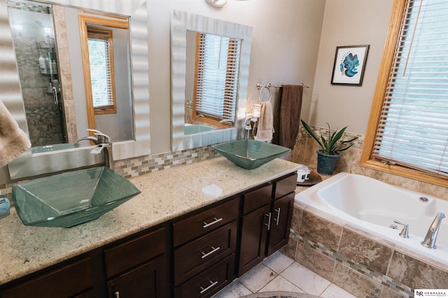 10955 N 58th Plz, Omaha, NE 68152 - bathroom with plenty of natural light, a garden tub, double vanity, and backsplash