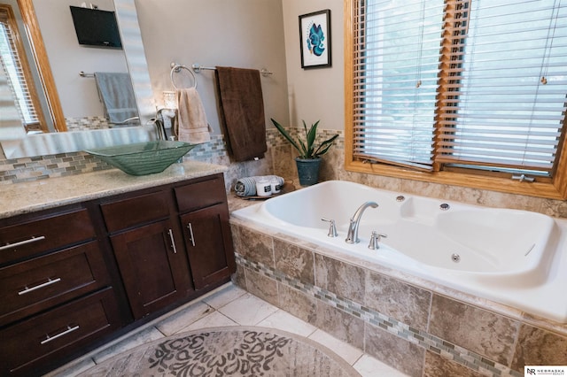 10955 N 58th Plz, Omaha, NE 68152 - bathroom featuring vanity, a tub with jets, and tile patterned flooring