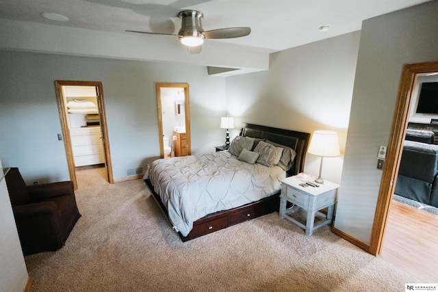10955 N 58th Plz, Omaha, NE 68152 - bedroom featuring light carpet, baseboards, a ceiling fan, connected bathroom, and a spacious closet