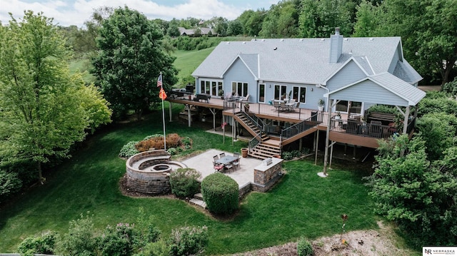 10955 N 58th Plz, Omaha, NE 68152 - rear view of house with a fire pit, a deck, a patio, stairs, and a lawn