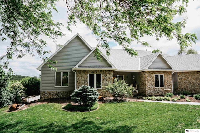 10955 N 58th Plz, Omaha, NE 68152 - view of front of property with stone siding, a front yard, and a shingled roof