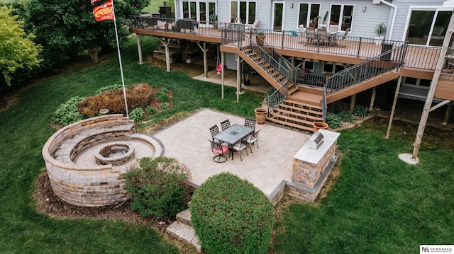 10955 N 58th Plz, Omaha, NE 68152 - view of grassy yard featuring stairs, a fire pit, a deck, and a patio area