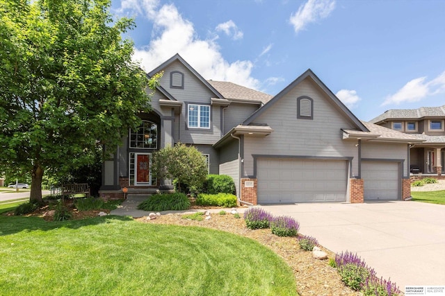 15210 Craig Cir, Bennington, NE 68007 - view of front facade featuring driveway, an attached garage, brick siding, and a front yard