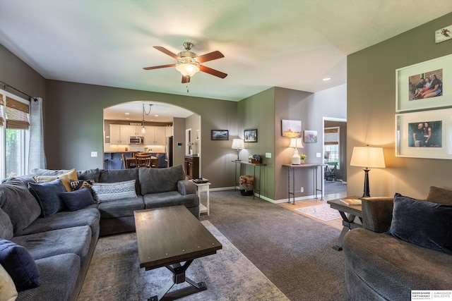 15210 Craig Cir, Bennington, NE 68007 - carpeted living room featuring arched walkways, a ceiling fan, plenty of natural light, baseboards, and recessed lighting