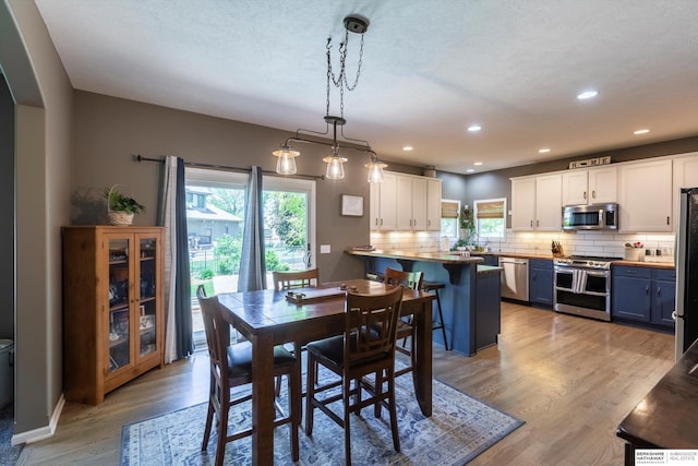 15210 Craig Cir, Bennington, NE 68007 - dining room featuring healthy amount of natural light, light wood finished floors, and recessed lighting
