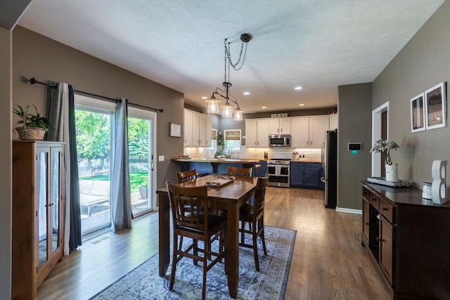 15210 Craig Cir, Bennington, NE 68007 - dining room with wood finished floors and recessed lighting