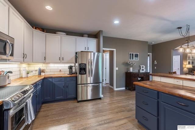 15210 Craig Cir, Bennington, NE 68007 - kitchen with wood counters, appliances with stainless steel finishes, blue cabinets, white cabinetry, and tasteful backsplash
