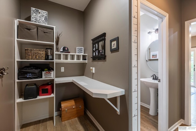 15210 Craig Cir, Bennington, NE 68007 - office area with wood finished floors, baseboards, and a sink