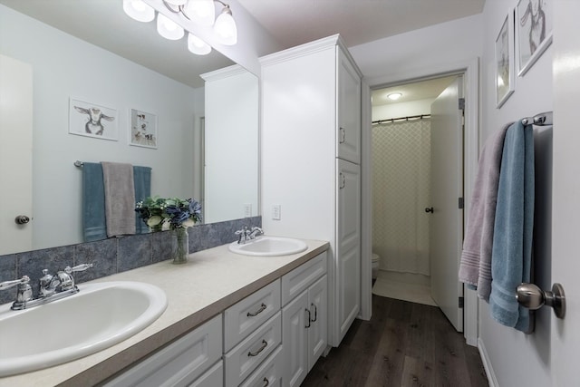 15210 Craig Cir, Bennington, NE 68007 - full bathroom with double vanity, toilet, wood finished floors, and a shower with shower curtain