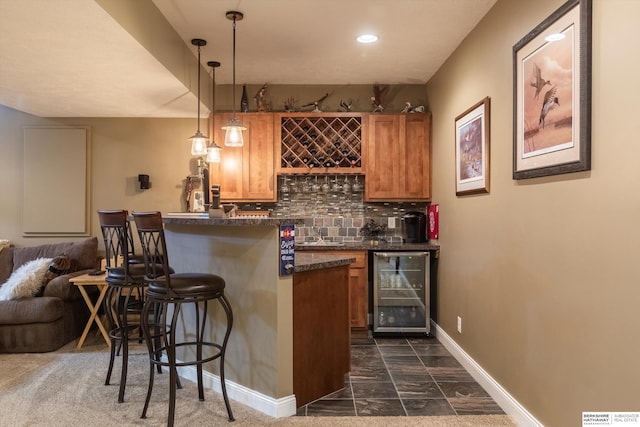 15210 Craig Cir, Bennington, NE 68007 - indoor bar with wine cooler, dark marble finish flooring, baseboards, decorative backsplash, and hanging light fixtures