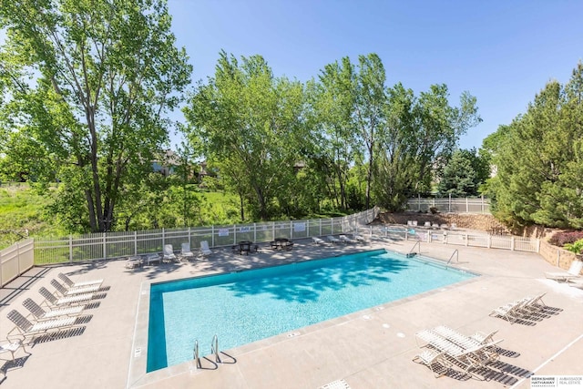 15210 Craig Cir, Bennington, NE 68007 - community pool with view of wooded area and a patio