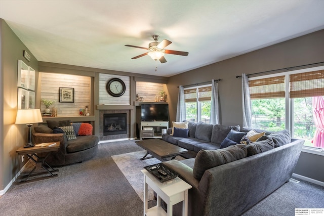15210 Craig Cir, Bennington, NE 68007 - carpeted living area featuring ceiling fan, healthy amount of natural light, baseboards, and a tile fireplace