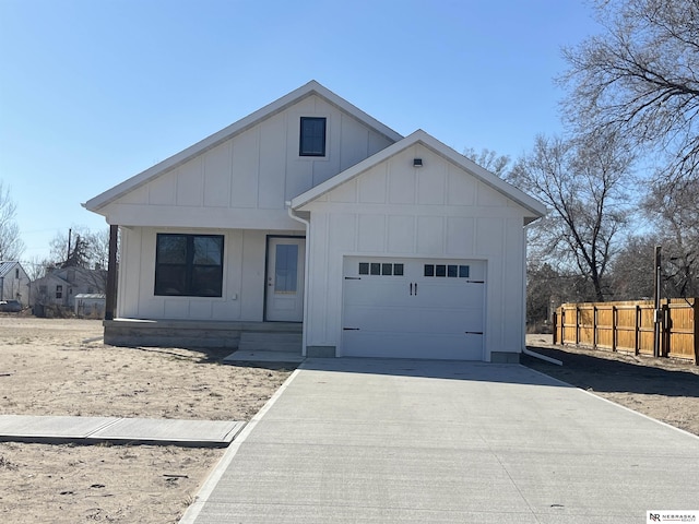 117 N Edna St, Valentine, NE 69201 - view of front of house featuring board and batten siding, a garage, concrete driveway, and covered porch