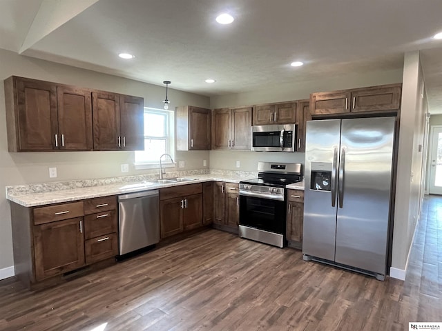 117 N Edna St, Valentine, NE 69201 - kitchen with appliances with stainless steel finishes, a sink, dark wood-style flooring, light countertops, and recessed lighting