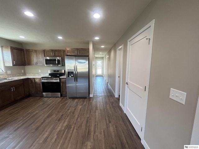 117 N Edna St, Valentine, NE 69201 - kitchen with stainless steel appliances, a sink, dark wood finished floors, light countertops, and recessed lighting