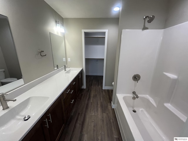 117 N Edna St, Valentine, NE 69201 - bathroom with toilet, wood finished floors, double vanity, shower / washtub combination, and baseboards