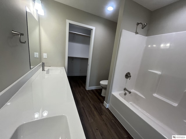 117 N Edna St, Valentine, NE 69201 - full bathroom featuring toilet, wood finished floors, baseboards, bathtub / shower combination, and double vanity
