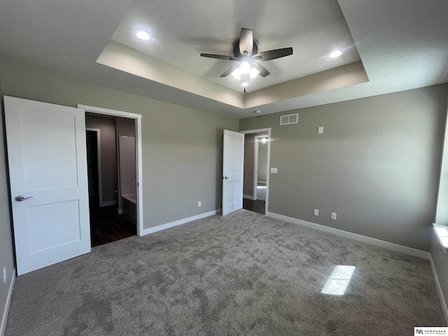 117 N Edna St, Valentine, NE 69201 - unfurnished bedroom featuring a raised ceiling, dark colored carpet, baseboards, and recessed lighting