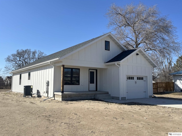 117 N Edna St, Valentine, NE 69201 - modern inspired farmhouse with board and batten siding, an attached garage, a porch, cooling unit, and concrete driveway