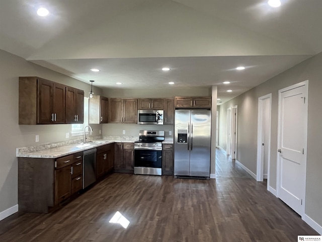 117 N Edna St, Valentine, NE 69201 - kitchen featuring appliances with stainless steel finishes, baseboards, dark wood-style floors, a sink, and vaulted ceiling
