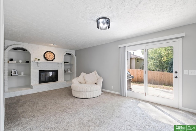 3501 Leawood Dr, Bellevue, NE 68123 - living area featuring a textured ceiling, a fireplace, carpet, built in features, and baseboards
