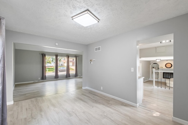 3501 Leawood Dr, Bellevue, NE 68123 - unfurnished room with light wood finished floors, a textured ceiling, and baseboards