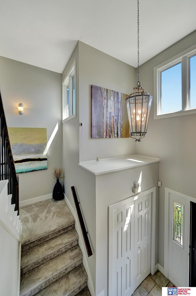 7627 S 38th St, Lincoln, NE 68516 - foyer featuring plenty of natural light, stairway, and baseboards